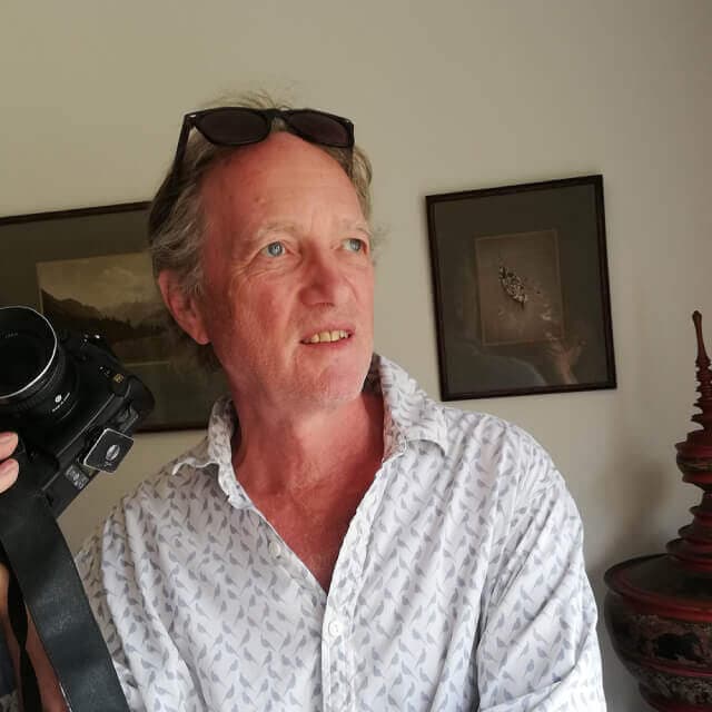 Peter Charlesworth holding a camera.