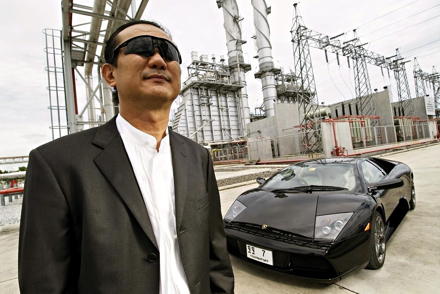 Vikrom Kromadit, CEO of Amata Corp., posing against a backdrop of the power supply plant for the massive Amata Nakorn Industrial Estate.