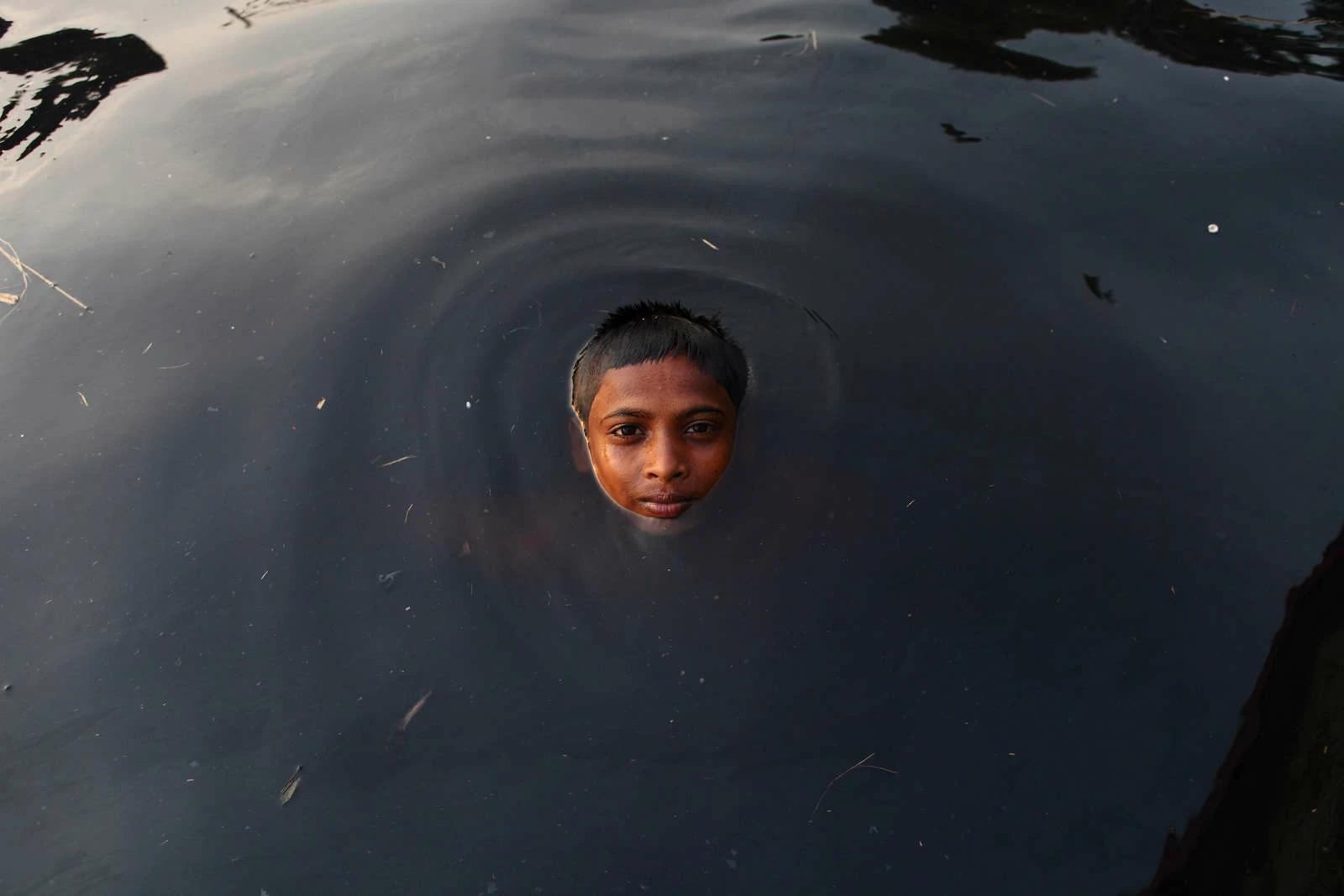 A young boy swimming in extremely polluted river water. The indiscriminate discharge of liquid waste by industries and factories in and around the Dhaka industrial zone has ruined a large part of the Buriganga river, causing immense suffering to residents living on the banks. Photo and story by Probal Rashid.
