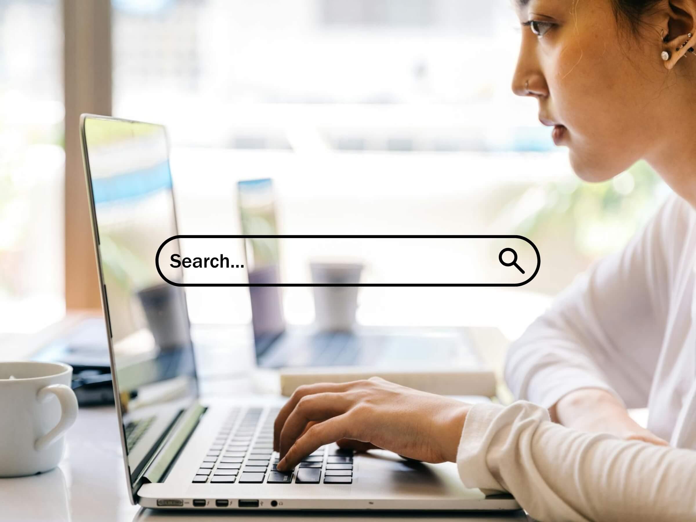 a woman working on a laptop with a search bar overlaid