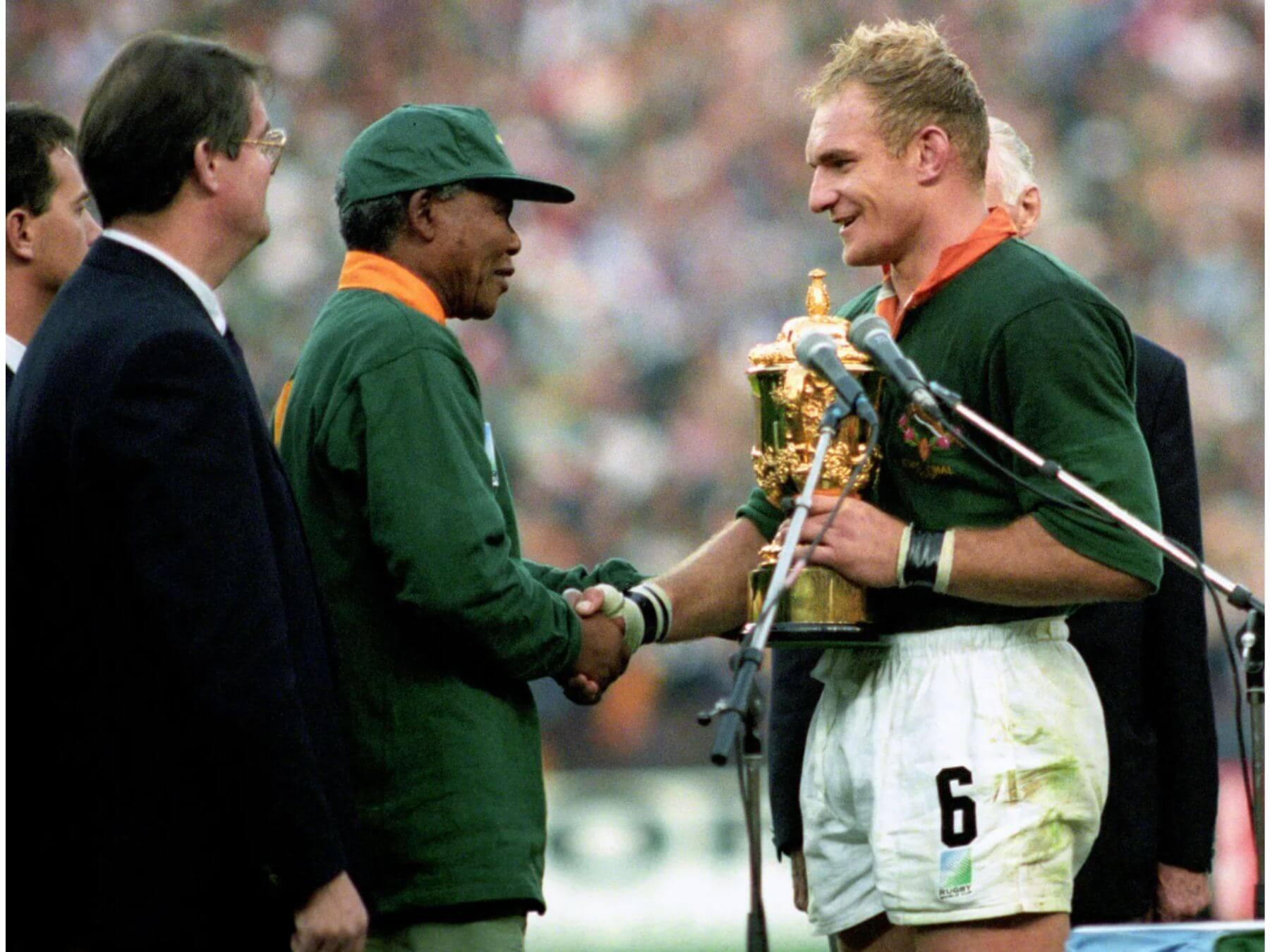 Nelson Mandela and Francois Pienaar shaking hands after winning the Rugby World Cup 1995