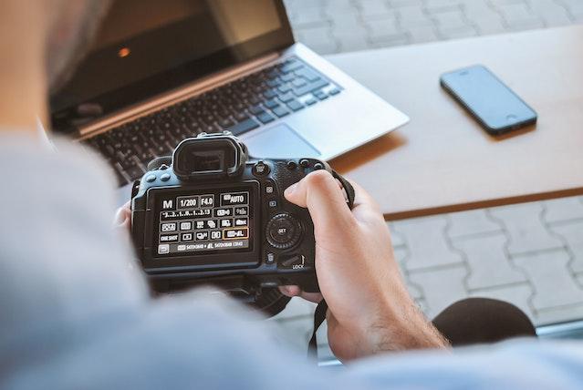 Person holding DSLR camera