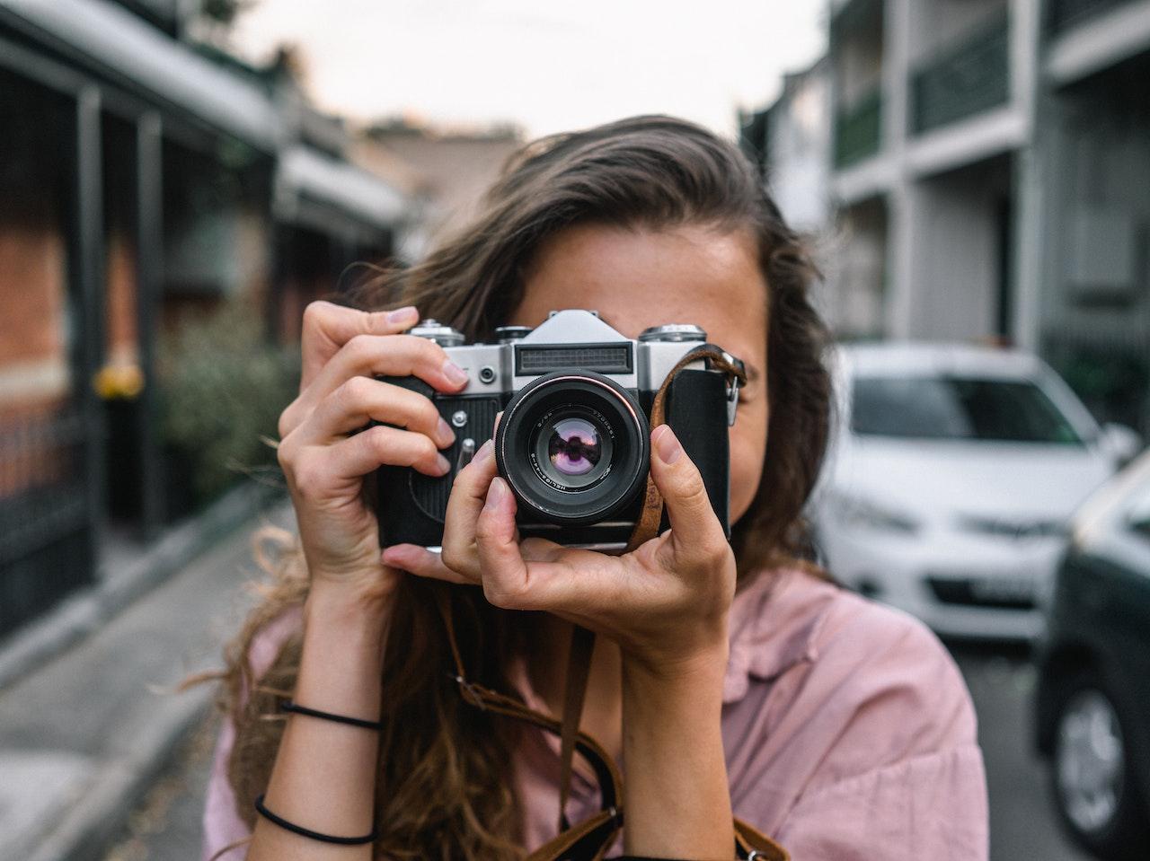 Woman pointing DSLR camera