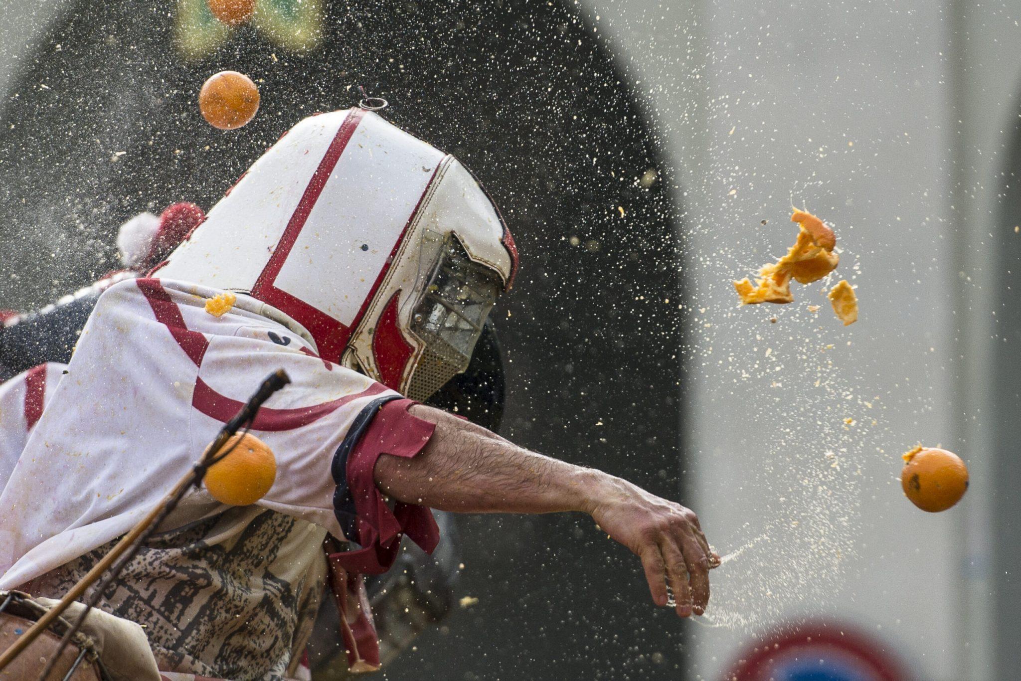A member of an orange battle team takes part in the traditional ‘battle of the oranges’ held during the traditional battle of the oranges during the Ivrea Carnival near Turin, Italy. Photo and story credits by Stefano Guidi