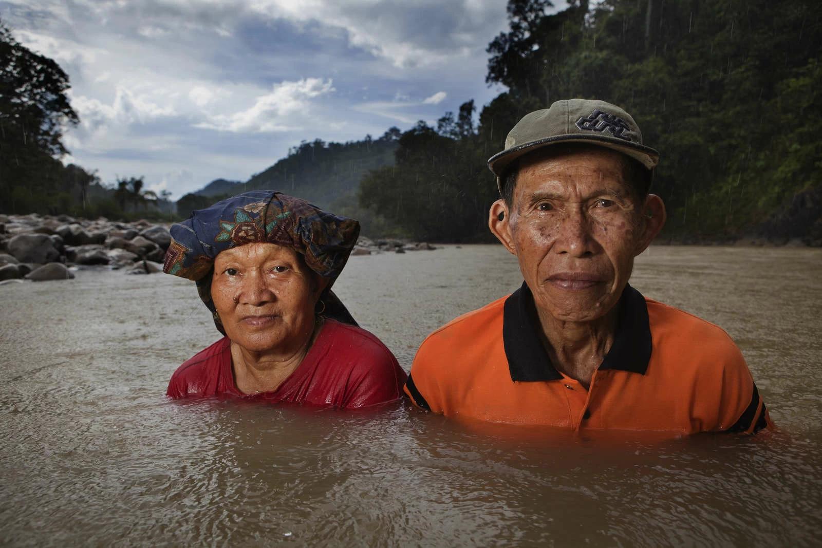 A Kelabit couple stand immersed in a river that passes through the village of Long Napir. A new dam project supported by the Malaysian government threatens to flood Long Napir and the surrounding forest areas which have been the homeland of the Kelabit and other tribal groups like the Penan since time immemorial. Photo and story credits to Yvan Cohen.