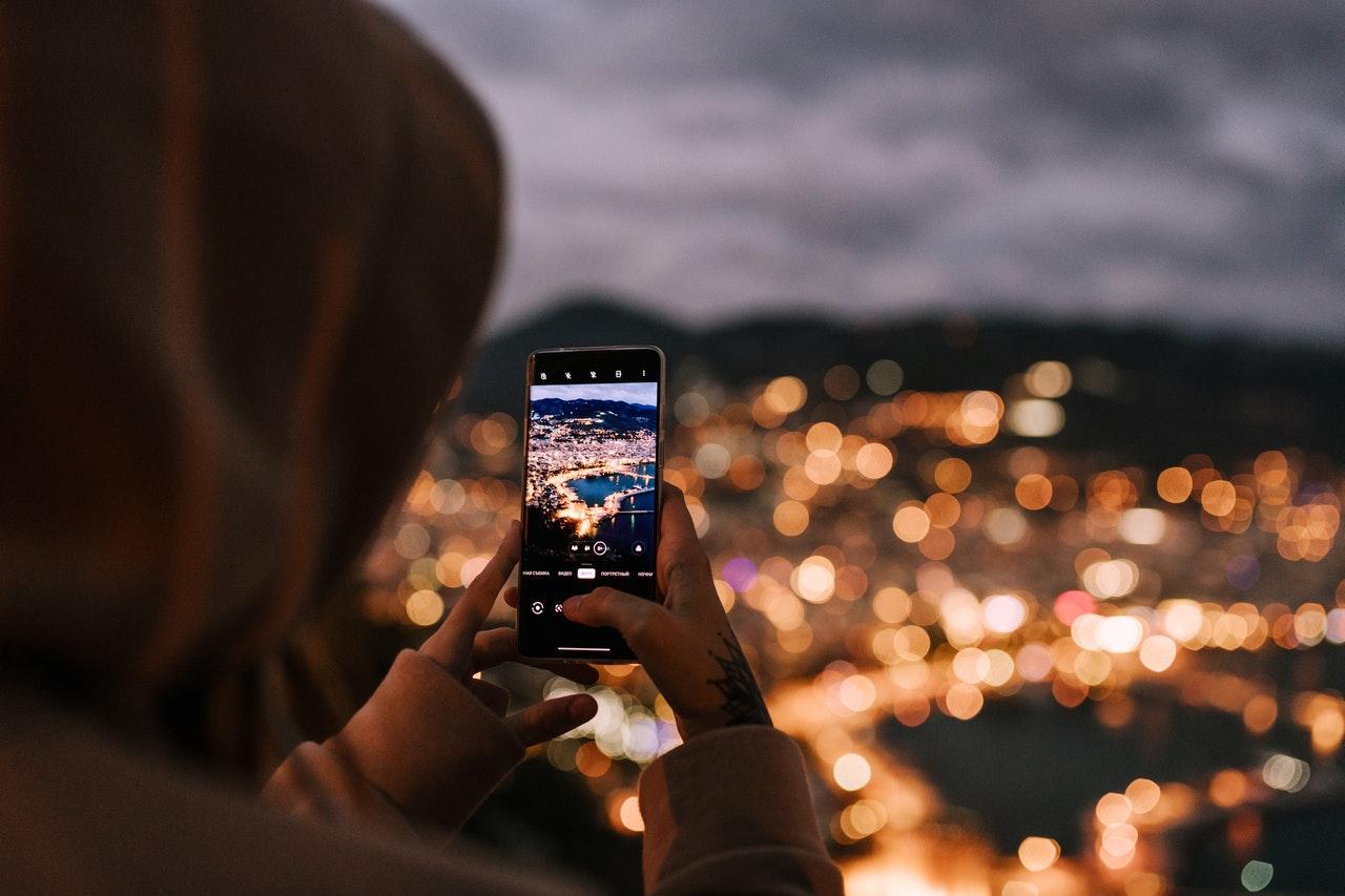 Woman taking a photography on her smartphone.