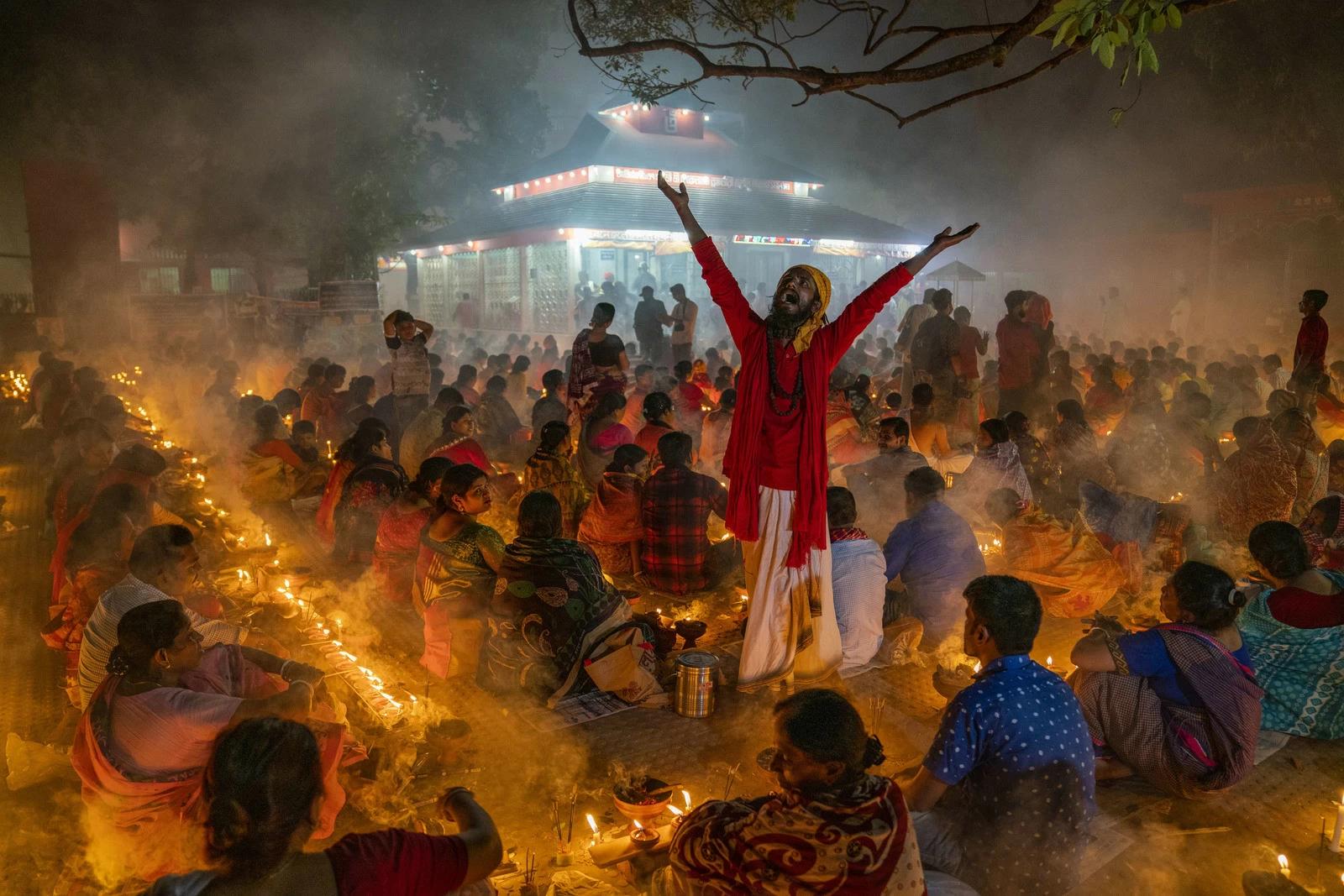 Hindu devotees sit with Prodip and pray to God at the Shri Shri Lokanath Brahmachari Ashram temple during the religious festival Kartik Brati, also known as Rakher Upobash in Barodi, Narayanganj, Dhaka, Bangladesh. Photo and story by Zabed Hasnain Chowdhury.