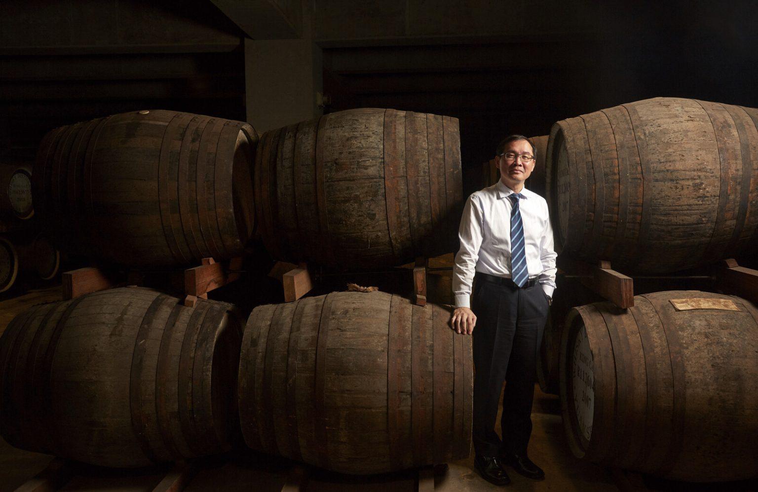 Lee Yu Ting, CEO of Kavalan, poses among whisky barrels in the warehouse area of the Kavalan distillery. By Craig Ferguson