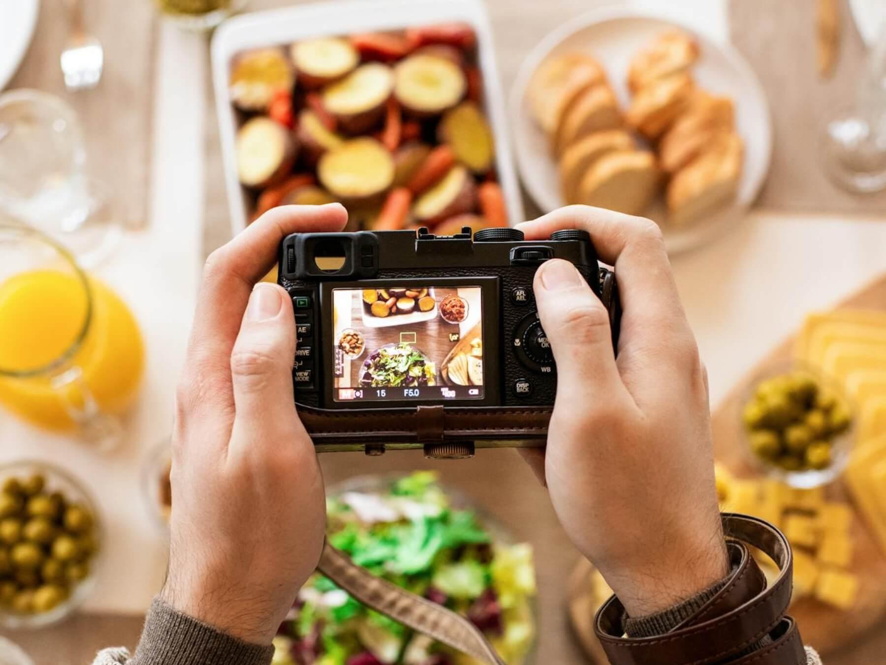 Person taking a photograph of food