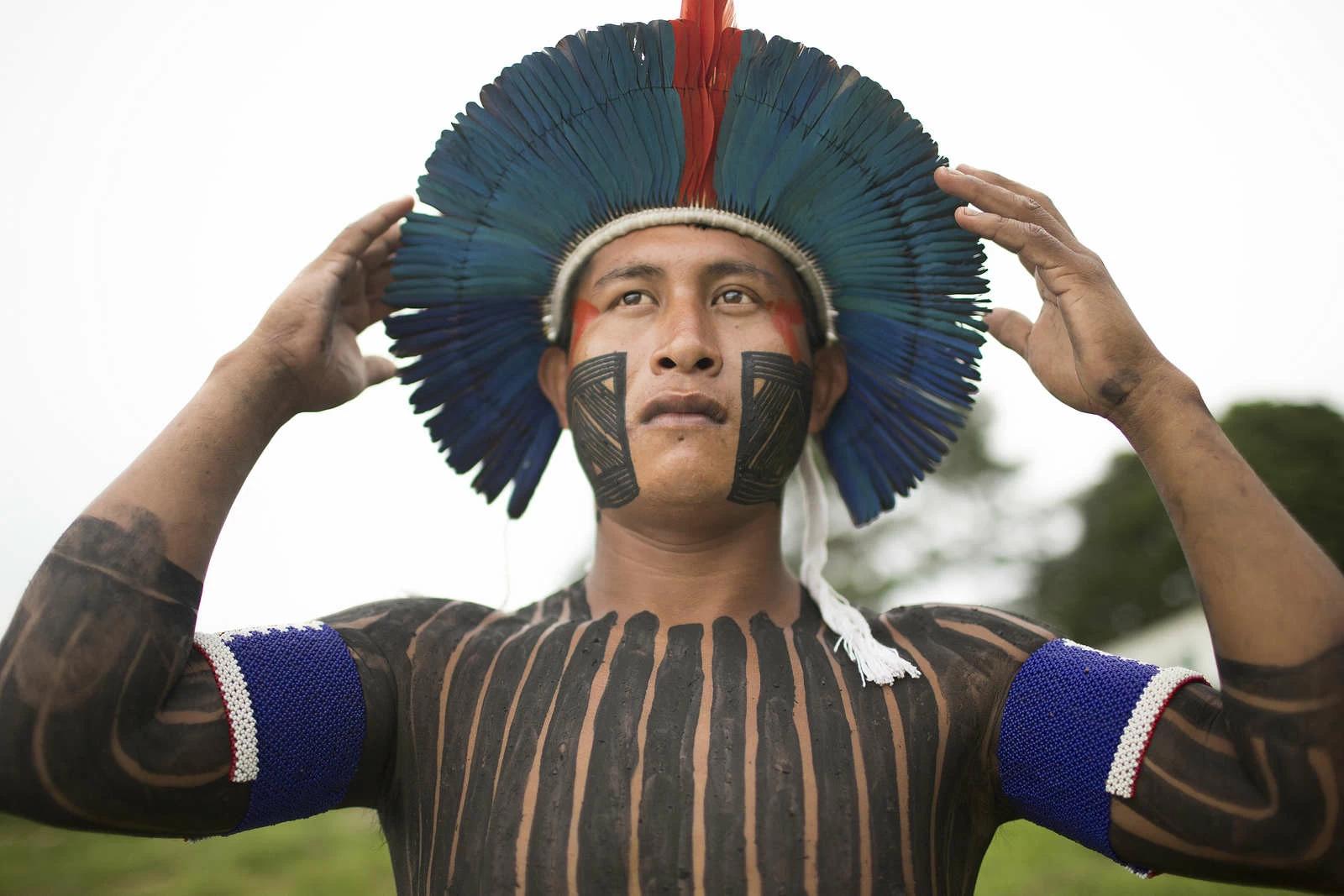 Mukuka, a young Xikrin leader of Poti-Kr village, is a “Warrior of the Knowledge of White Men,” in which he plays a role similar to that of an ambassador. He says he feels stronger and prouder when he is painted and dressed in traditional ceremonial garb. The indigenous Xikrin people live on the Bacaja, a tributary of the Xingu River, where construction of the Belo Monte Dam is reaching peak construction. Some scientists warn that the water level of the Bacaja will decrease precipitously due to the dam. Photo and story credits by Taylor Weidman.