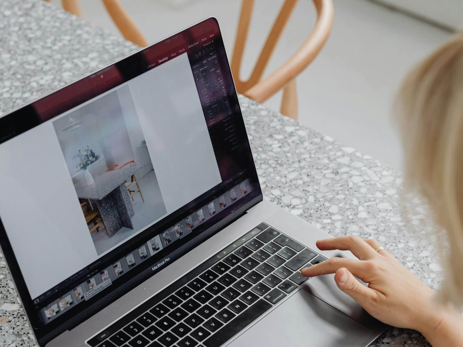 A person looking at photos on a laptop