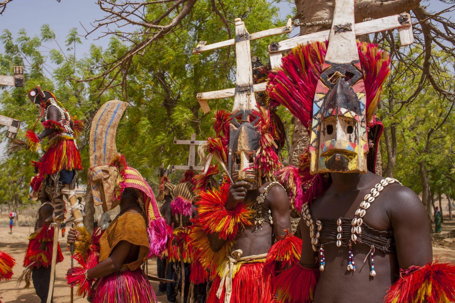 Dogon people (men only) in traditional dance costumes in the village of Sangha in the Dogon country in Mali, West Africa. Photo and story credits by Wolfgang Kaehler