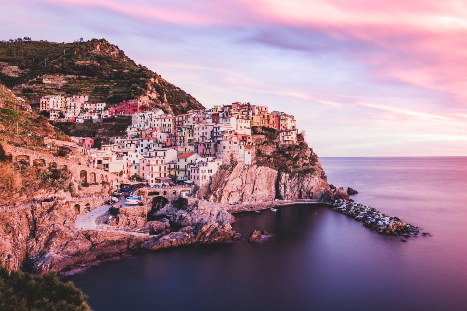 Italy, Cinque Terre National Park: Panoramic side view of Manarola, one of the five coastal villages of the Cinque Terre national park, at sunset. Photo and story credits by Alessandro Bosio