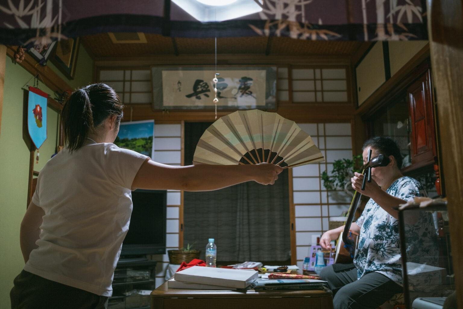 Woman holding a traditional fan.