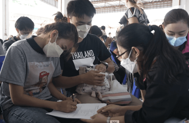 Grieving parents fill out official forms at the scene of the shooting. Photo by Yvan Cohen