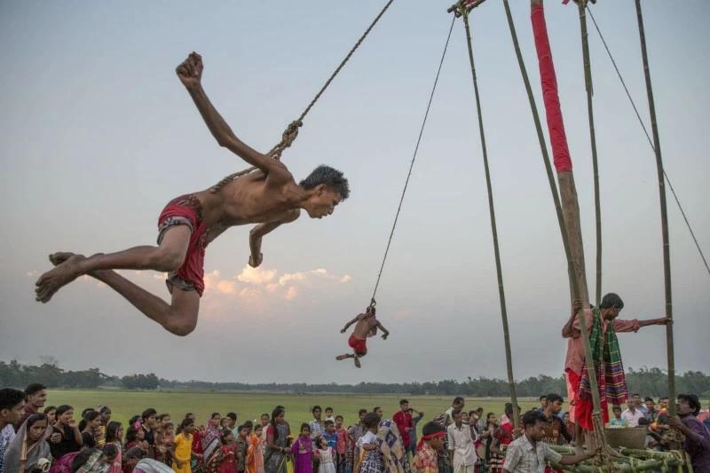 After body piercing and swirling hanging the devotees with charak tree for moving during ‘Charak Puja’ in Sylhet. It is also known as “Nil Puja”.