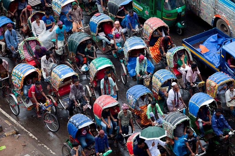 Rickshaw puller stuck in a traffic signal in Paltan, Dhaka. In the last 10 years, the average traffic speed in Dhaka has dropped from 21 km/hour to 7 km/hour, only slightly above the average walking speed. Congestion in Dhaka eats up 3.2 million working hours per day, according to the World Bank. See more from K M Asad here.